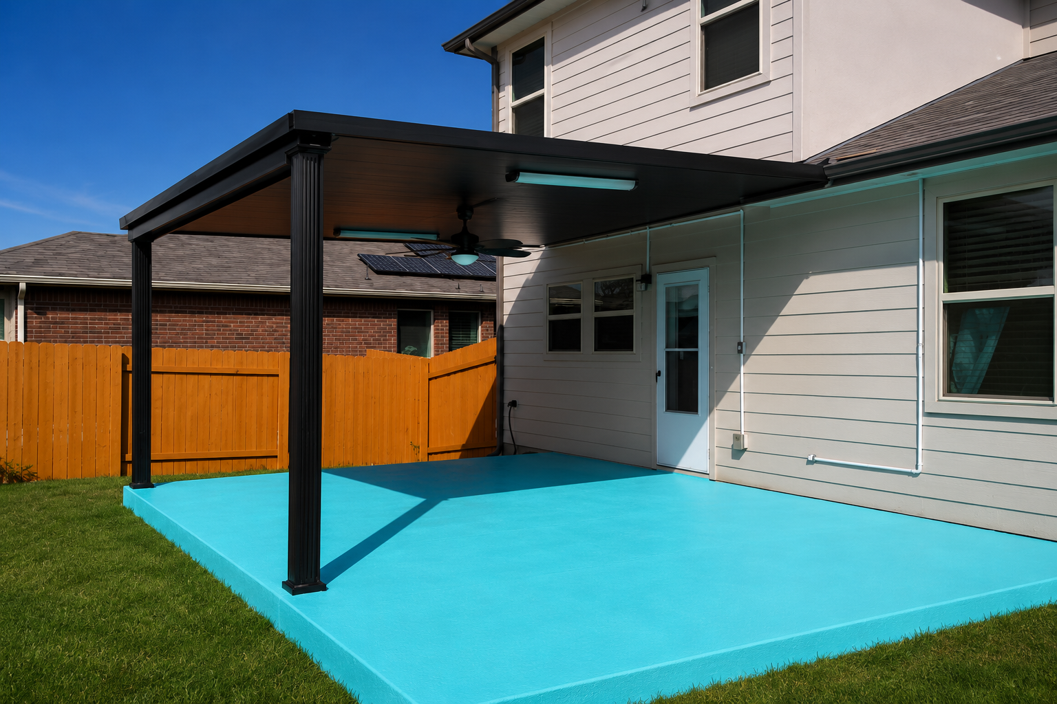 Completed covered patio with a black roof and outdoor living slab