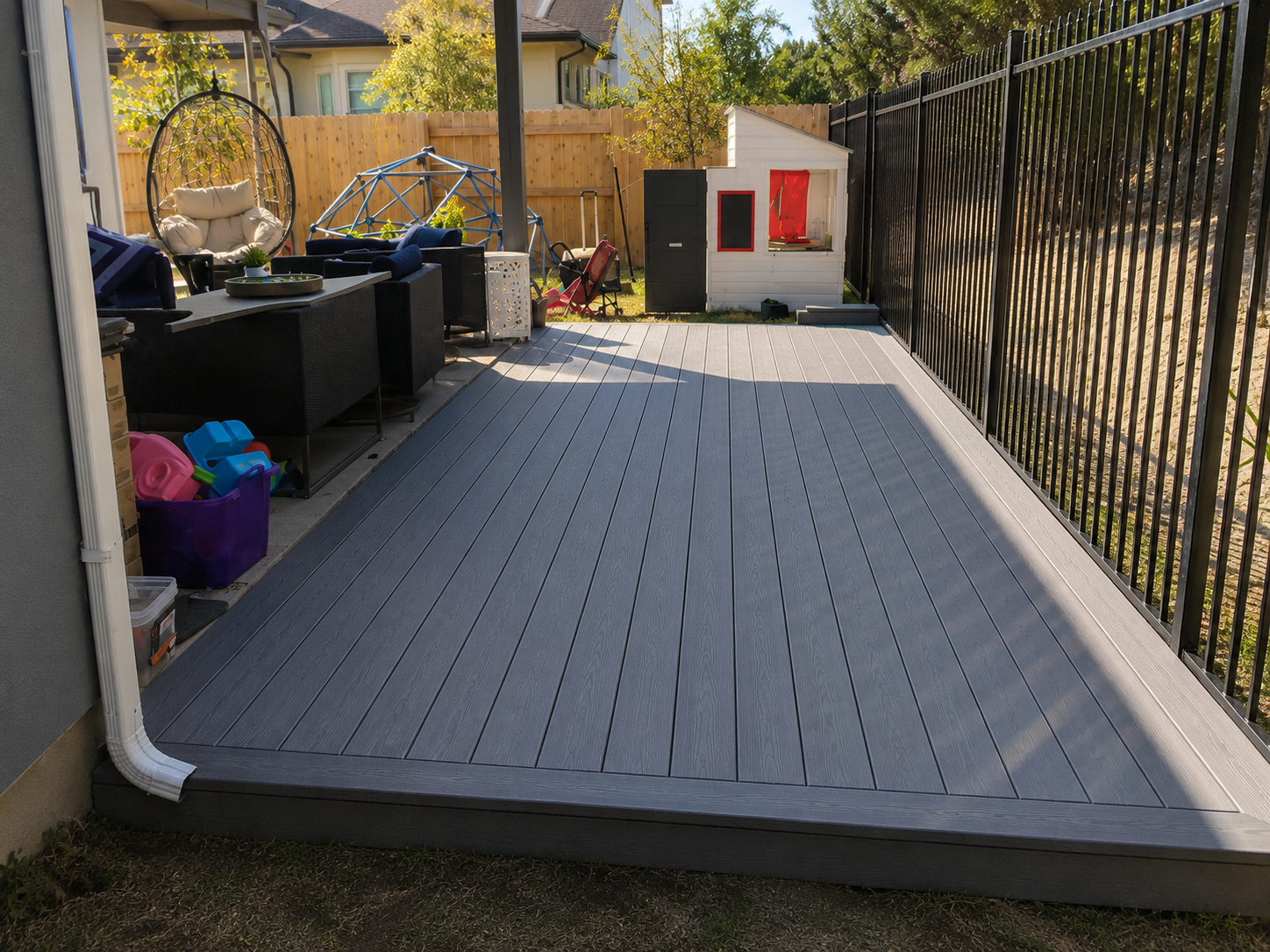 Completed outdoor deck with seating and a black railing